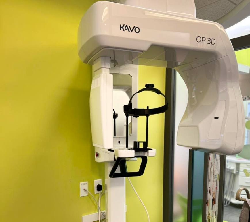 Cone beam scanner against light green wall of dental office