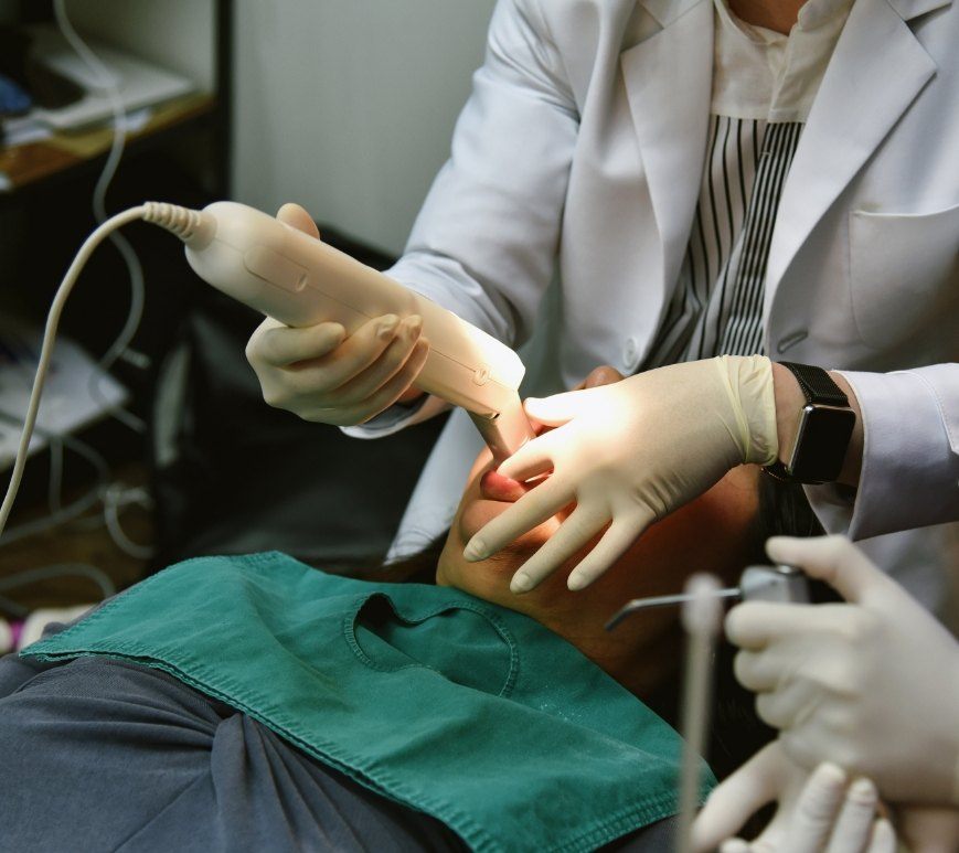 Dentist taking impressions of teeth