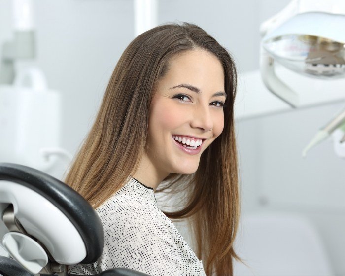 Woman grinning in dental chair