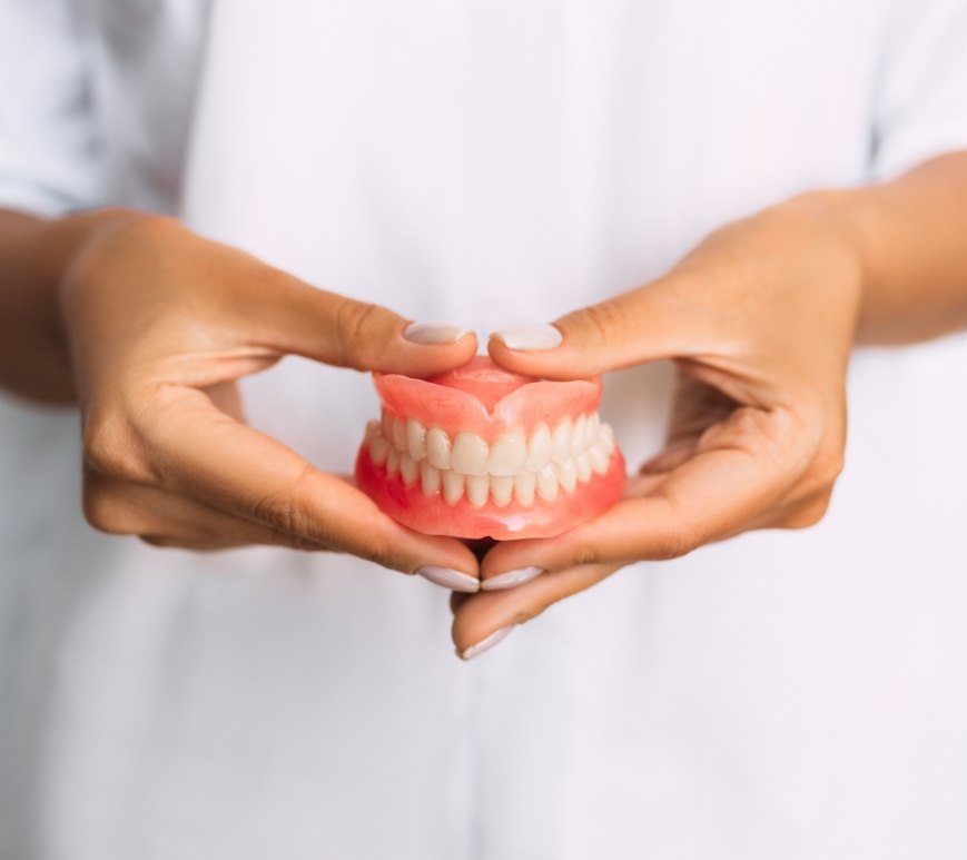 Dentist holding a set of full dentures