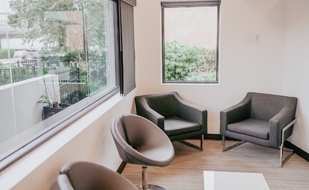 Two black armchairs by a window