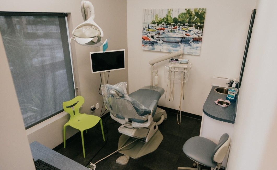 Dental treatment room with photo of boats on wall