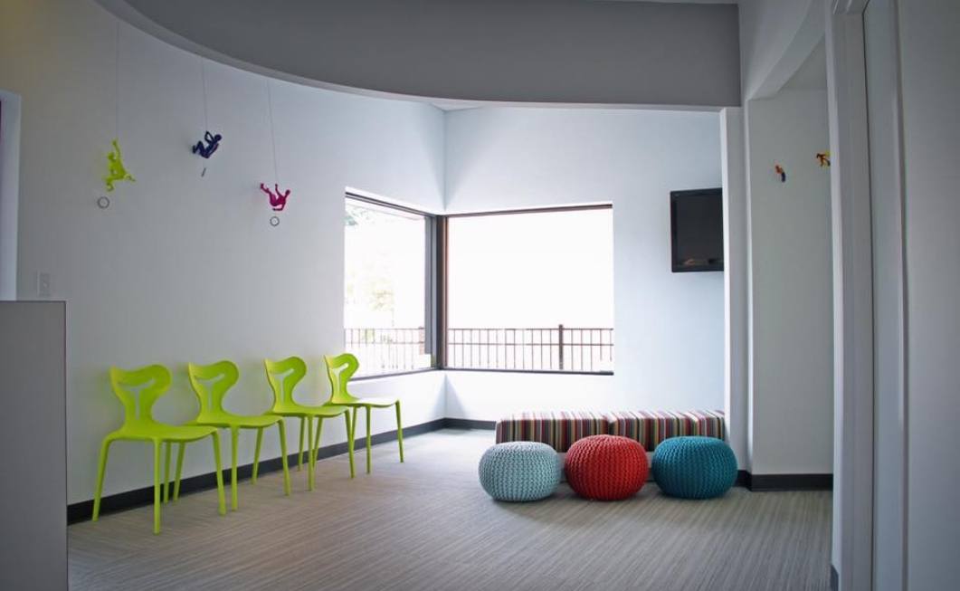 Plastic chairs and bean bag chairs in dental office reception area