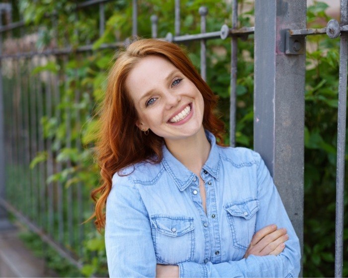 Woman in denim shirt smiling