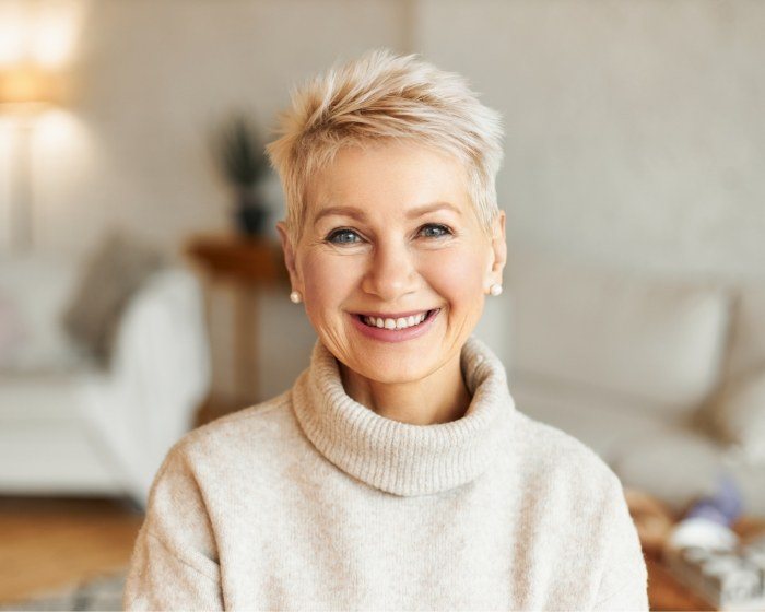 Smiling older woman in white sweater